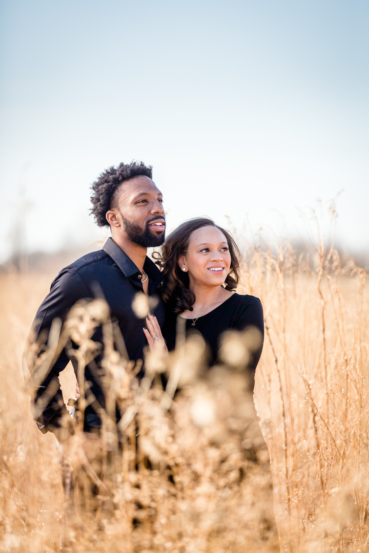 black couple standing in open field